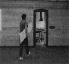 Кадр из триады (человек вносит доску в комнату)